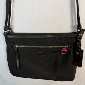 TUMI Black Crossbody Travel Bag. Multiple zipper compartments. Save your back!